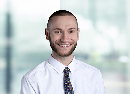 George Burkett on light blue and white bokeh banner